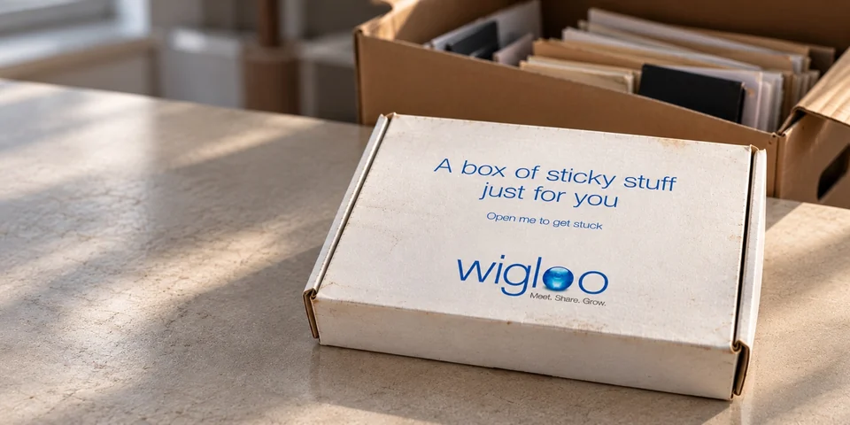 White Wigloo launch box labeled “A box of sticky stuff just for you,” photographed in front of a storage box.